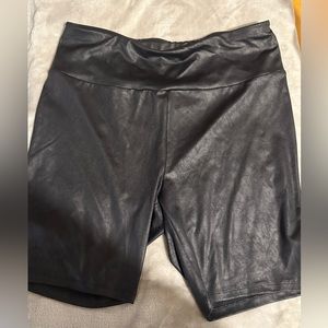 Shiny black biker style shorts. Size X